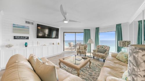 a living room with a couch and a tv at Inlet Reef 607 - Beach Front and Spacious with Free Beach Service in Destin