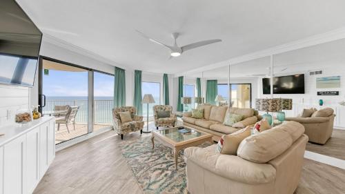 a living room with couches and a view of the ocean at Inlet Reef 607 - Beach Front and Spacious with Free Beach Service in Destin
