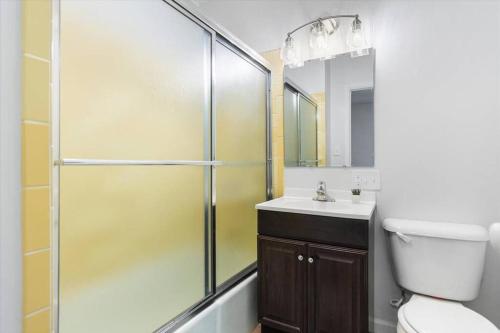 a bathroom with a shower and a toilet and a sink at 214: Lovely fully furnished 1 bedroom! in Billings