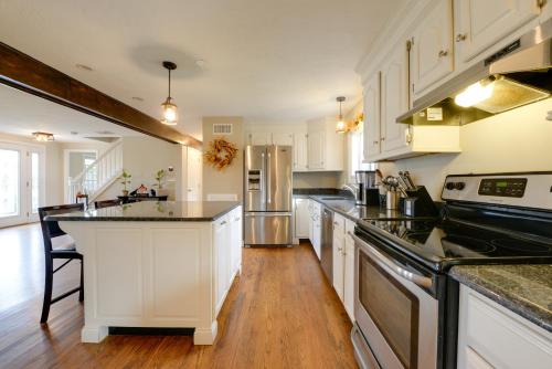 a kitchen with white cabinets and black counter tops at Spacious Oxford Home with Pool - 4 Mi to Lake! in Oxford