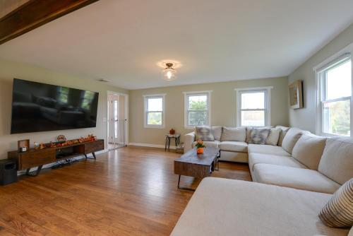 a living room with a couch and a flat screen tv at Spacious Oxford Home with Pool - 4 Mi to Lake! in Oxford