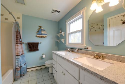 a bathroom with a sink and a toilet and a mirror at Spacious Oxford Home with Pool - 4 Mi to Lake! 