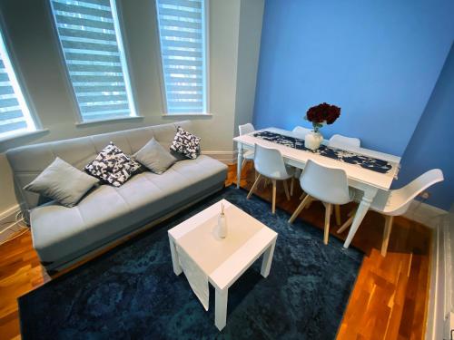 a living room with a couch and a table at 3-Bedroom Flat Central London, 6 Min Walk from King's Cross Station in London