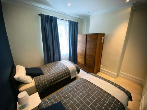 a bedroom with two beds and a window at 3-Bed Flat Central London, 6 Min Walk from King's Cross Station in London