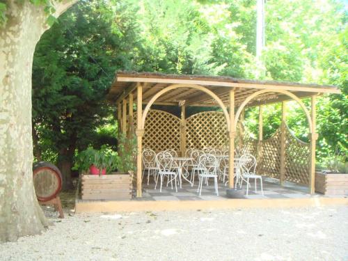 a wooden gazebo with white chairs and tables at Studio « Istanbul » à Avignon in Avignon