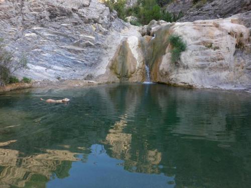 a person swimming in a body of water at Càmping Organyà Park in Organyà
