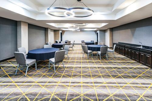 a conference room with tables and chairs and a whiteboard at Holiday Inn & Suites Stillwater-University West by IHG in Stillwater