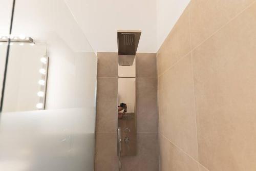 a shower in a bathroom with a person taking a picture at Cas'aPina apartment in Aci Bonaccorsi