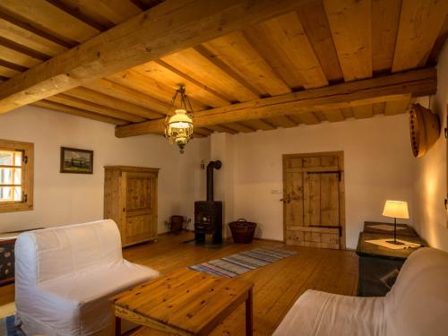 a living room with a white couch and a table at Drevenica Traditional Cottage Old Centre in Zuberec