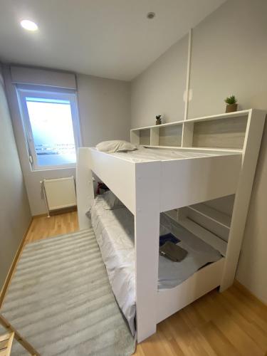 a white bunk bed in a room with a window at LA MARIEFACTURE - Comme à la Caserne 