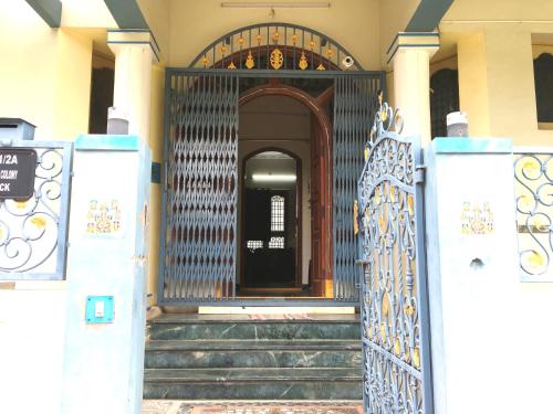 an entrance to a building with a gate and stairs at jayaram Home in Chittoor