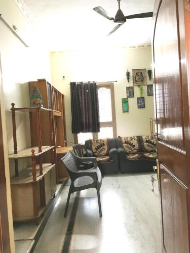 a living room with a couch and a chair at jayaram Home in Chittoor