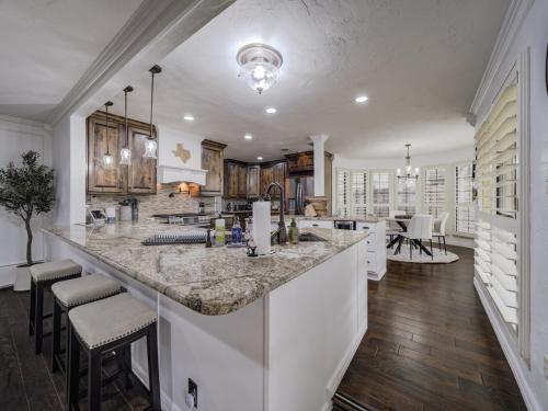 a kitchen with a large marble counter top and chairs at Trophy Haven Retreat With Pool in Roanoke