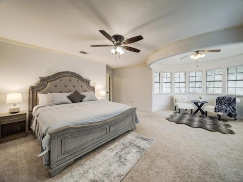 a bedroom with a bed and a ceiling fan at Trophy Haven Retreat With Pool in Roanoke