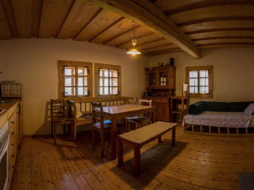 a living room with a table and a couch at Drevenica Traditional Cottage Old Centre in Zuberec