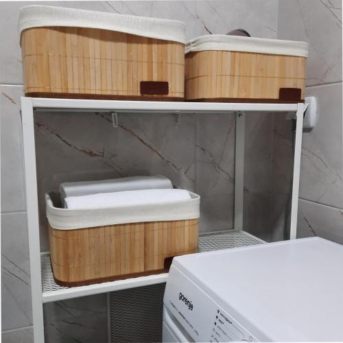 a shelf with wooden containers and a microwave at Dino & Gorge Apartments in Gevgelija