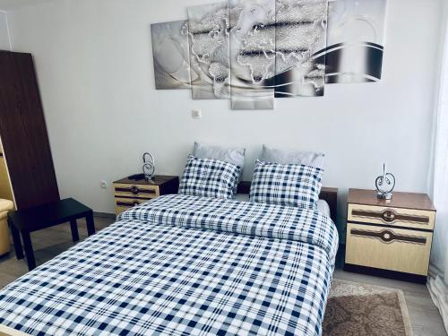 a bedroom with a bed with a checkered blanket at Chambre et SDD privées dans une maison partagée avec des résidents in Mons