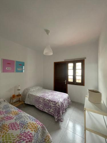 a bedroom with two beds and a window at Casa Barrera in Tigaday