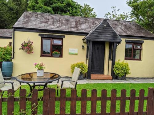 a small yellow house with a table in front of it at Cornflower in Saundersfoot