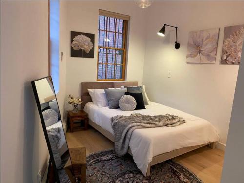 a bedroom with a bed with a blanket on it at 334-1 2BR - 1Bath prime Dumbo in Brooklyn