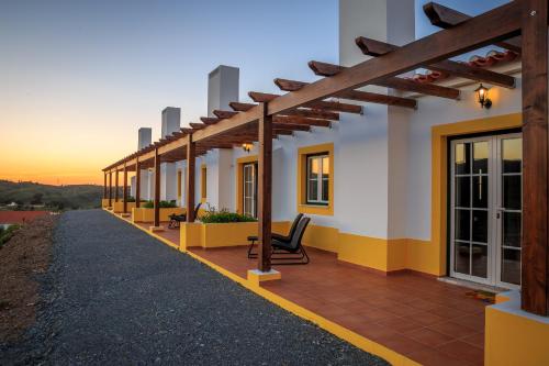 a building with a patio with chairs on it at Nave Redonda do Cerro – Countryside & Nature in Nave Redonda