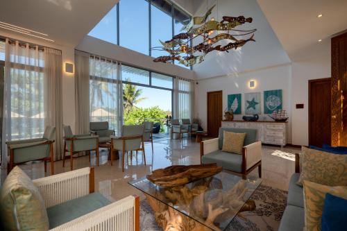 a living room with chairs and a table at Beacon By The Bay Villas and Suites by the Clarks in Matara