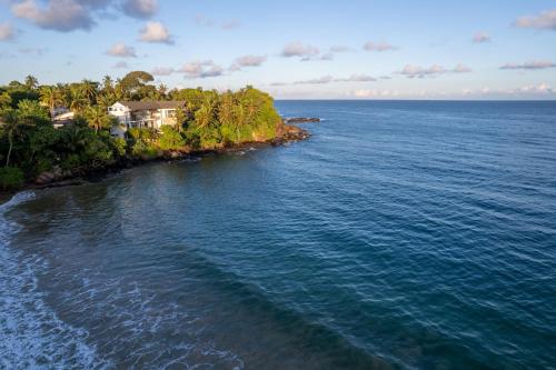 an aerial view of a house on an island in the ocean at Beacon By The Bay Villas and Suites by the Clarks in Matara