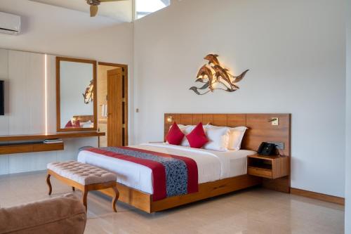 a bedroom with a king sized bed and a couch at Beacon By The Bay Villas and Suites by the Clarks in Matara