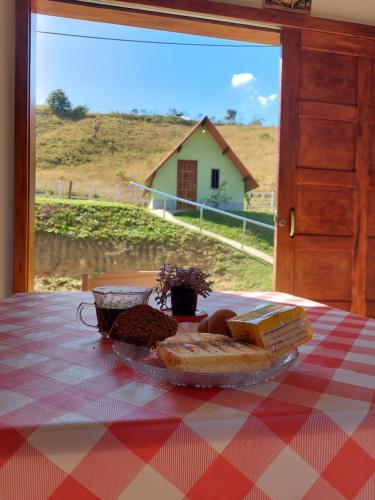 a plate of food on a table with a plate of bread at Pousada e Pesque e Pague Vista Alegre in Paty do Alferes