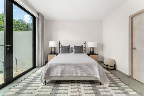 a bedroom with a bed and a large window at Casa Loba Luxe Unit 3 with private pool in Rincon