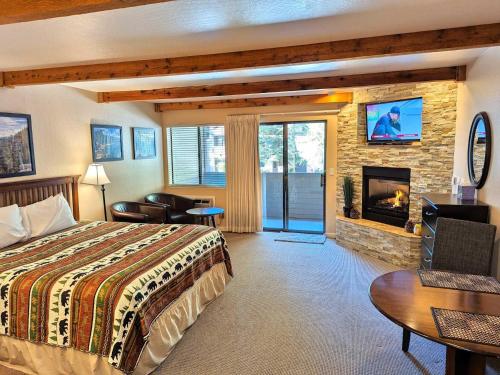 a hotel room with a bed and a fireplace at Lakeland Village #105 in South Lake Tahoe