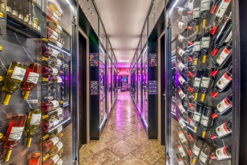 a room filled with lots of bottles of wine at SecretJaco - Luxury Beach Front Penthouse with Pool & Jacuzzi in Jacó