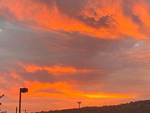 an orange sunset with clouds in the sky at Mountain house in Palmerton