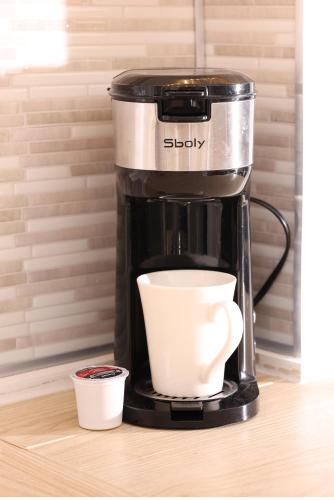 a coffee maker with a cup on a counter at bedford - Urban escape in Montréal