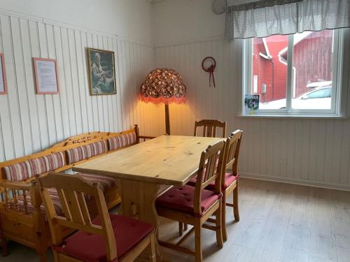 a dining room with a wooden table and chairs at Skraddaren, close to Vasaloppet finish line portal in Mora