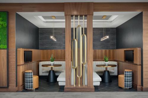 a rendering of a restaurant with tables and chairs at Courtyard by Marriott Bozeman in Bozeman