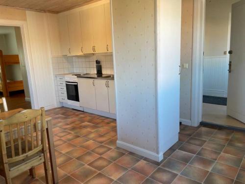a kitchen with white cabinets and a table and a counter top at Skomakaren, near Vasalopp finish line portal in Mora in Mora