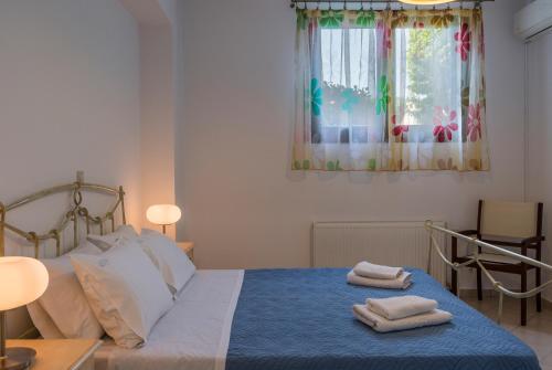 a bedroom with a bed with two towels on it at Villa Katerina in Chania