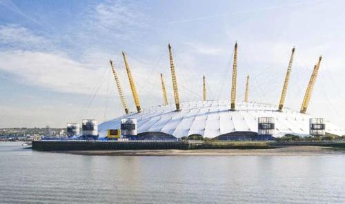 a large building in the middle of a body of water at London Dockside Apartment in London