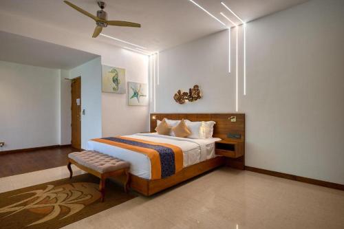 a bedroom with a bed and a ceiling fan at Beacon By The Bay Villas and Suites by the Clarks in Matara