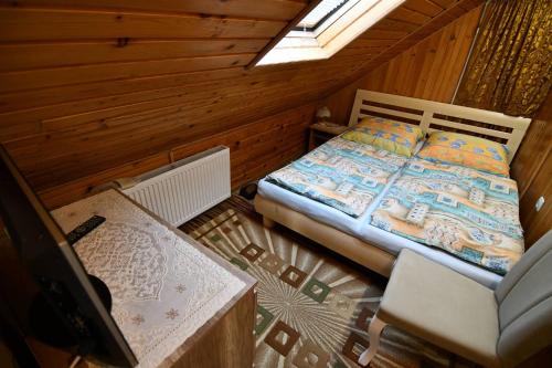 a bedroom with a bed and a chair in a room at Ubytovanie u Jozefa / Strba in Štrba