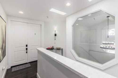 a white bathroom with a tub and a mirror at Live Above Shops and Restaurants in Oldtown Scottsdale in Scottsdale