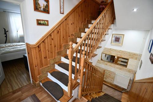 a wooden staircase with black carpeting in a house at Ubytovanie u Jozefa / Strba in Štrba
