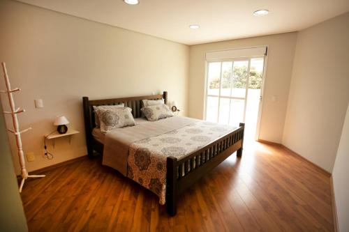 En eller flere senge i et værelse på Natureza na cidade