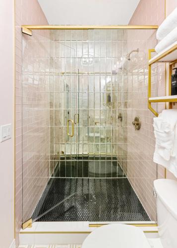 a bathroom with a glass shower with a toilet at The Acoma House in Denver
