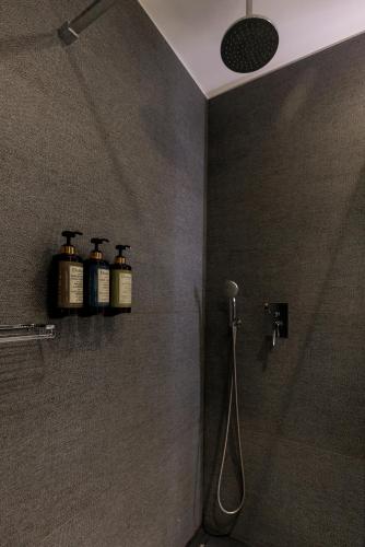 a bathroom with three bottles of soap on a shelf at Hotel Pax Guadalajara in Guadalajara