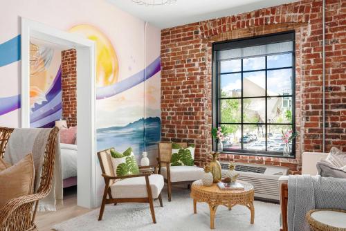 a living room with a brick wall at The Acoma House in Denver