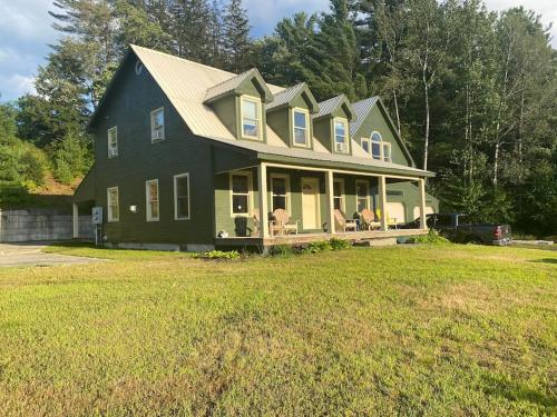 a large house with a large yard at Northern Vermont custom home near Stowe & Smuggs in Johnson