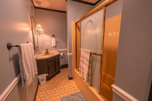 a small bathroom with a sink and a shower at Cheerful Chalet - Fireplace, BBQ, Firepit& Hottub in Long Pond