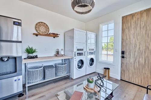 a white laundry room with two washer and dryer at Inn History Grand Canyon Cabin in Williams